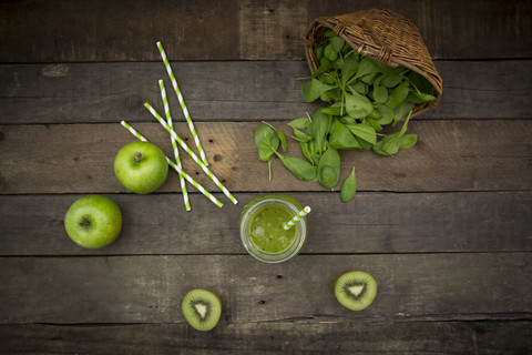 Glass of apple kiwi spinach smoothie and ingredients stock photo