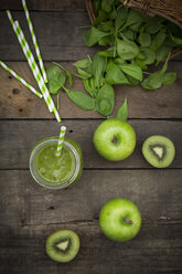 Glass of apple kiwi spinach smoothie and ingredients - LVF003968