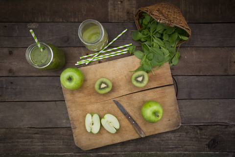 Two glasses of apple kiwi spinach smoothie and ingredients stock photo