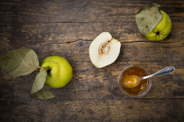 Quinces and a glass of quince jam on wood - LVF003985