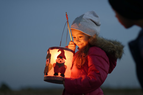 Smiling little girl with self-made paper lantern in the evening stock photo