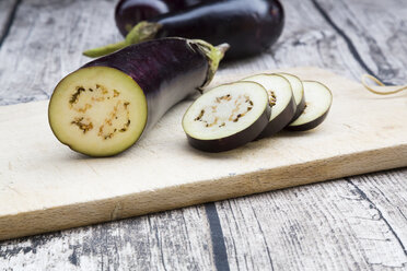 Aubergines on chopping board, knife - LVF003996