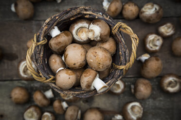 Crimini mushrooms in basket and on wood - LVF004001