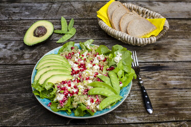 Quinoa salad with feta, pomegranate, avocado and snow peas on plate - SARF002207