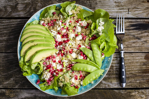 Quinoa salad with feta, pomegranate, avocado and snow peas on plate - SARF002208