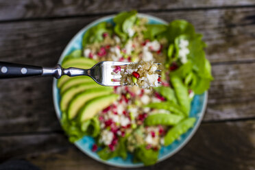 Quinoa salad with feta, pomegranate, avocado and snow peas on plate - SARF002211