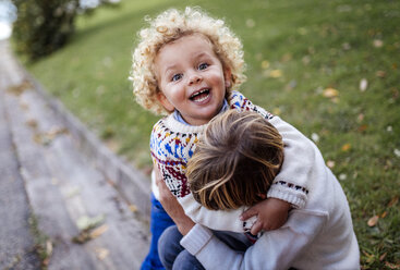 Two blond brother playing together in autumn - MGOF000864