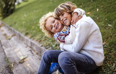 Two blond brother playing together in autumn - MGOF000865