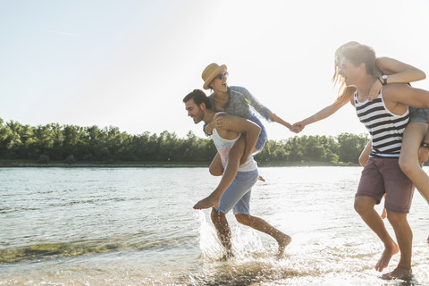 Two playful young couples at the river stock photo