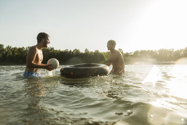 Zwei Freunde mit Schlauch und Ball im Wasser - UUF005888