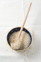 Bowl of quinoa with wooden spoon - MYF001173