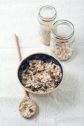 Bowl of fruit muesli with quinoa and wooden spoon - MYF001176