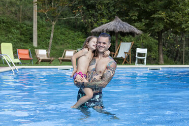 Spain, Girona, tattooed man with his daughter in a swimming pool - XCF000039