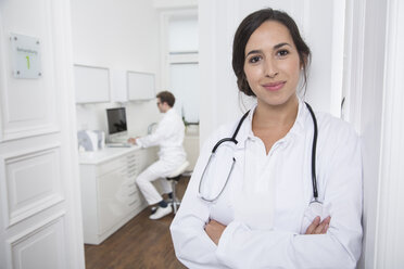 Portrait of smiling doctor at medical practice - FKF001491