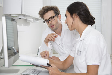 Two doctors at desk discussing - FKF001499