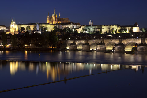 Czechia, Prague, view to lighted Prague Castle and Charles Bridge at night stock photo