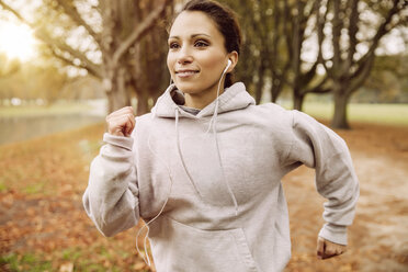 Woman jogging in park during autumn - MFF002452