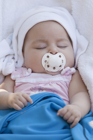 Portrait of sleeping baby girl with pacifier stock photo