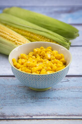 Organic corncob on wood, maize in bowl - LVF004053