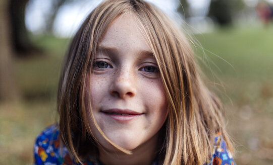 Porträt eines lächelnden Mädchens mit Sommersprossen - MGOF000945