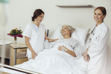 Ältere Frau im Krankenhaus im Gespräch mit Krankenschwester und Arzthelferin - MFF002462