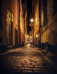 Sweden, Stockholm, Gamla Stan, lighted alley by night - MPAF000044