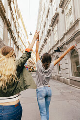 Austria, Vienna, back view of two female friends exploring the old town - AIF000117