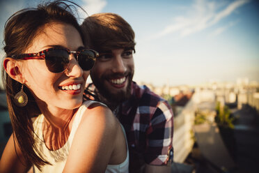 Austria, Vienna, Young couple enjoying romantic sunset on rooftop terrace - AIF000127