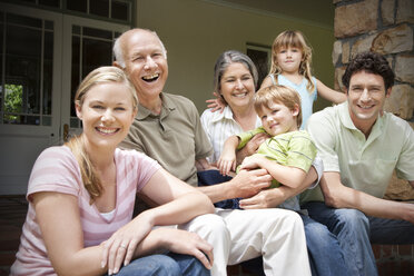 Group picture of three generations family sitting on the terrace - RMAF000019