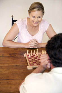 Portrait of woman playing chess with her husband - RMAF000036