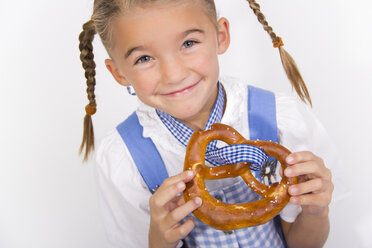 Portrait of smiling little girl with pretzel - YFF000470