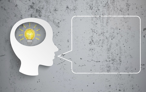 Human head with bulb and speech bubble on concrete background, vector graphics stock photo