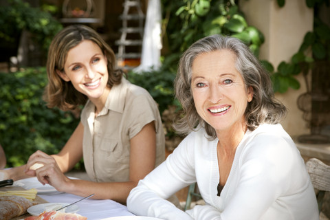 Portrait of smiling mature woman and young woman in the background stock photo
