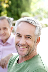 Portrait of smiling man with grey hair and stubble - RMAF000112