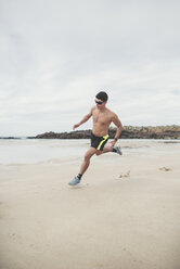 Spain, Ferrol, young man running fast on the beach - RAEF000600