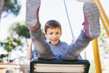 Happy boy on a swing at the playground - EBSF000995