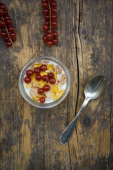 Glass of yogurt with muesli, cornflakes and red currants - LVF004091