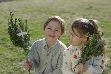 Germany, Upper Bavaria, little boy and girl with Palmbusch on a meadow - LBF001268