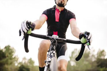 Cyclist riding a racing cycle, handlebar - JRFF000160