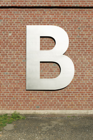 Letter B on brick wall stock photo