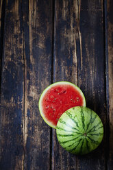 Sliced mini watermelon on dark wood - CSF026657