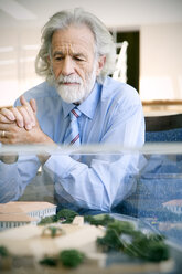 Senior man studying architectural model - RMAF000181