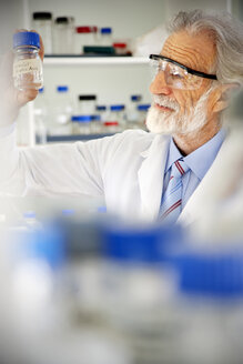 Senior professor looking at laboratory glass - RMAF000186