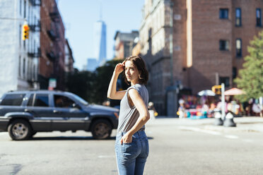 USA, New York City, woman standing on a street - GIOF000395