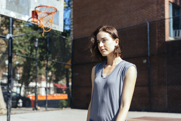 USA, New York City, Manhattan, young woman standing on a playground - GIOF000397