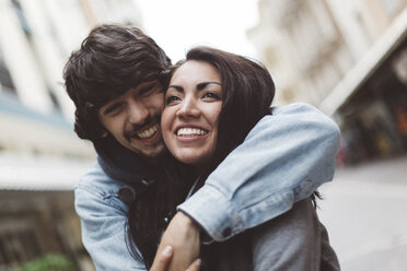 Italy, Rimini, happy couple hugging in the city - GIOF000440