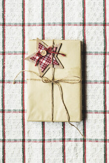 Wrapped Christmas present on checked cloth - AKNF000029