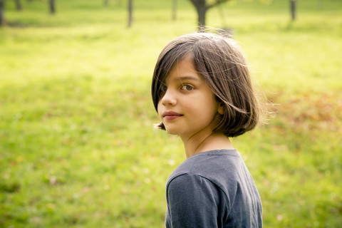 Portrait of girl looking over her shoulder stock photo