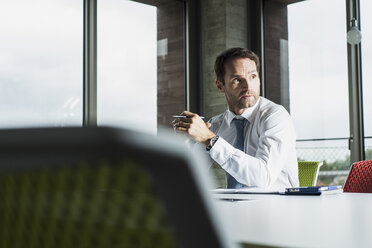 Porträt eines Geschäftsmannes an seinem Schreibtisch im Büro - UUF005983