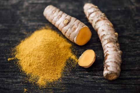 Fresh Curcuma and powder on wood stock photo